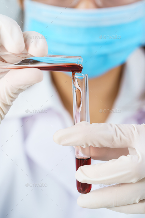 Scientist analyzing holding blood sample in test tube Stock Photo by stoonn